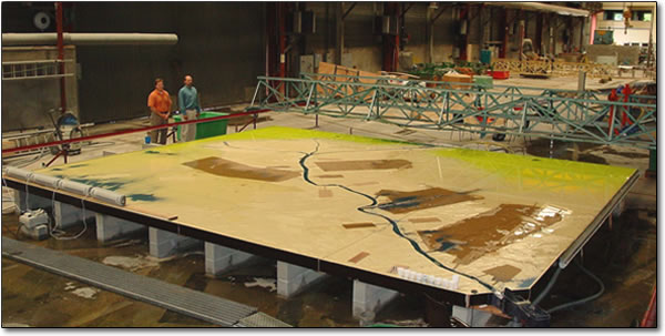 DNR project manager Shannon Dupont and Coastal Engineering Division Director Christopher Knotts review the model of river in Sogreah’s laboratory in Grenoble, France in July 2003.