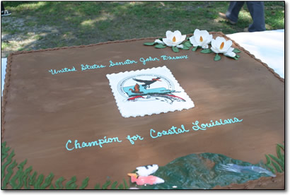 A large chocolate cake fit for an outdoor festival crowd was presented by Plaquemines Parish officials to the Senator.